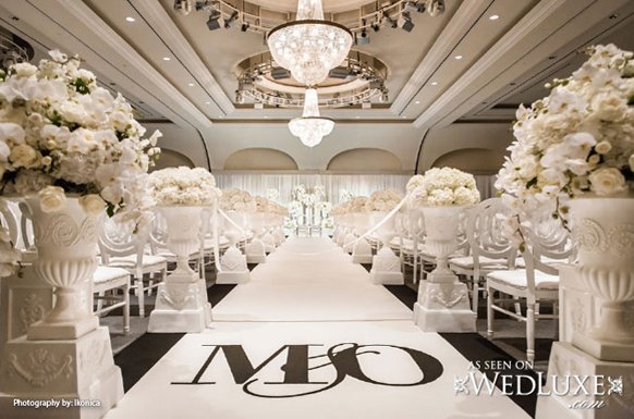 stylish white indoor wedding ceremony decorations