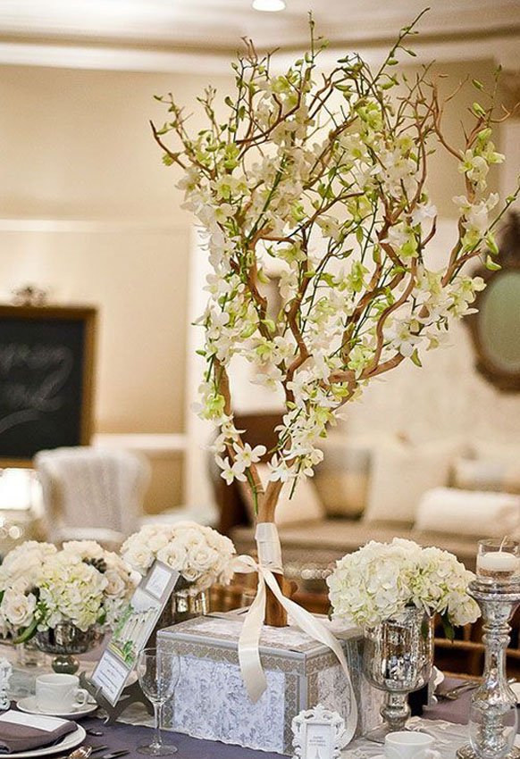 Tall white orchids manzanita branch wedding centerpiece idea