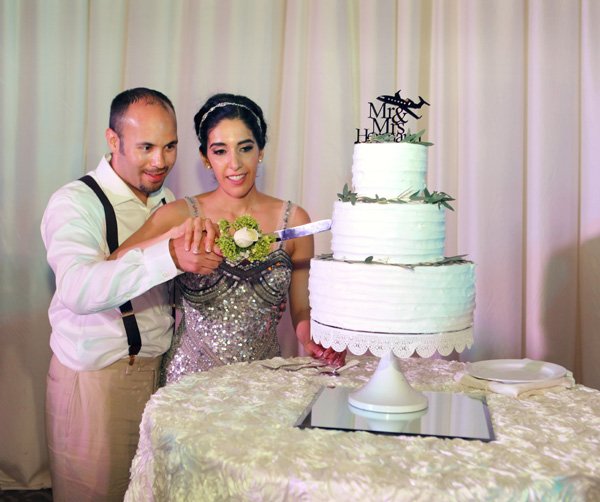 Bohemian Chic wedding couple cutting cake by Weddings Romantique